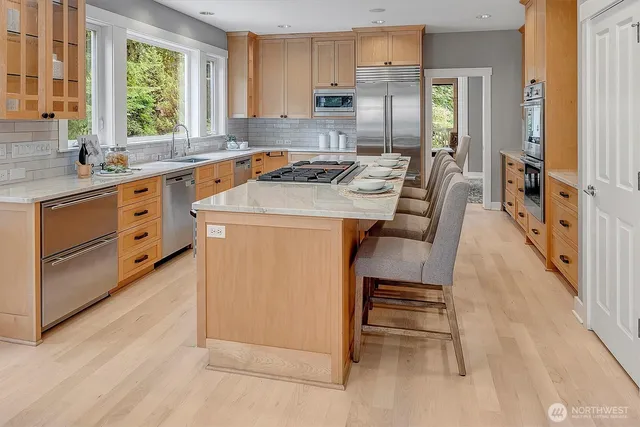 a kitchen with a stove a sink and a refrigerator