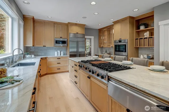 a kitchen with stove a sink and a refrigerator