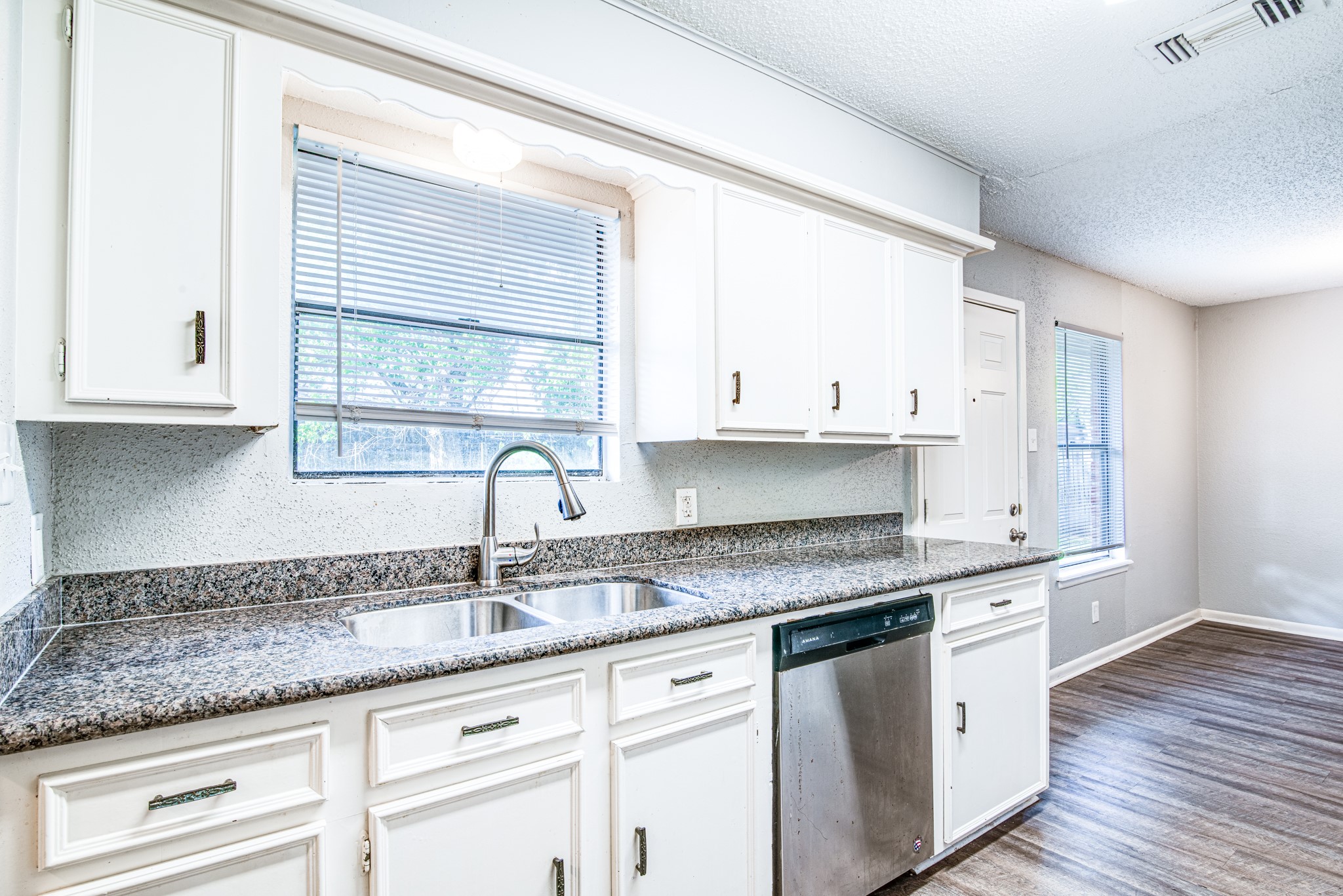 828 Noreda Street Angleton, TX 77515 - Photo 1 of 28 a kitchen with granite countertop white cabinets and a sink