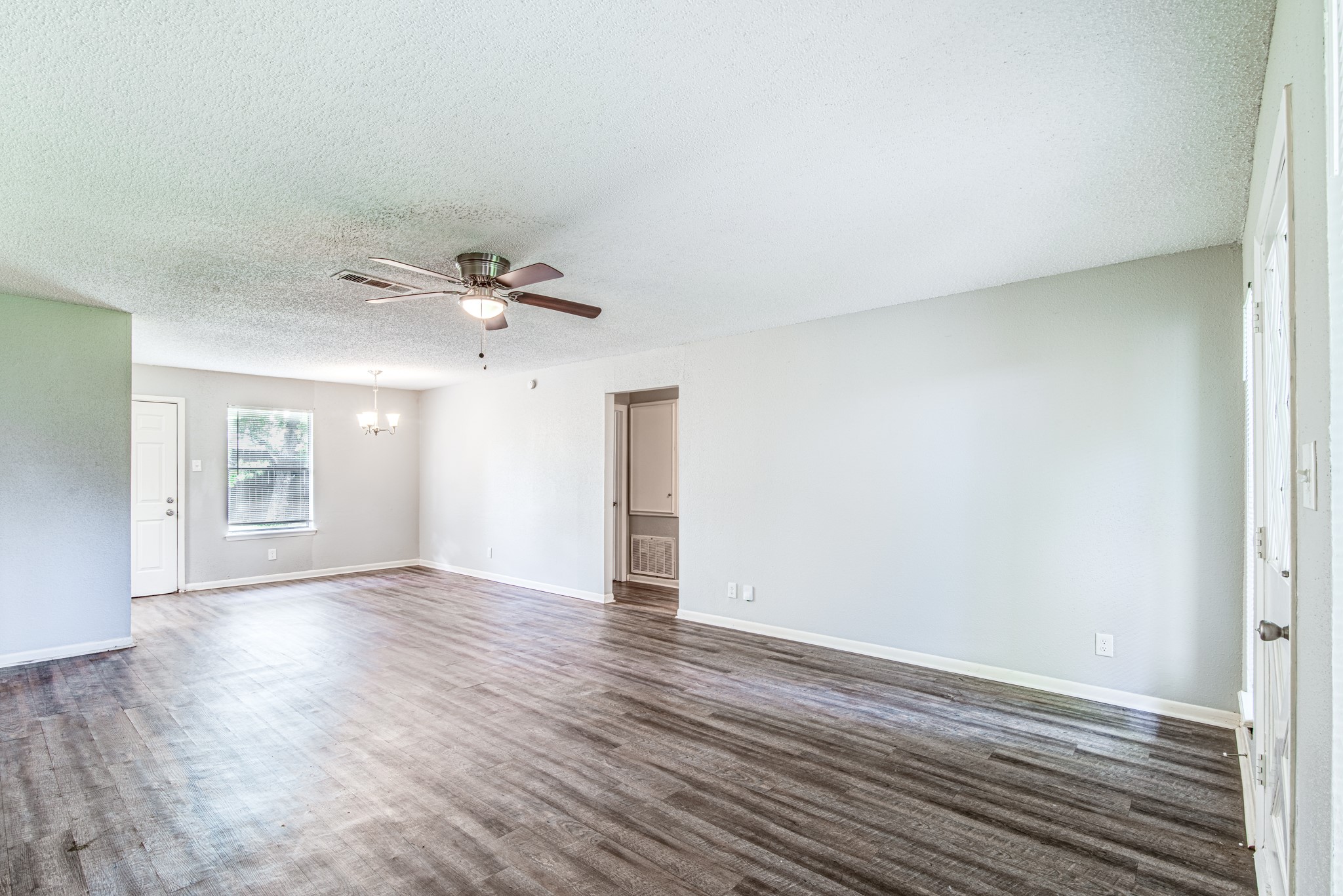 828 Noreda Street Angleton, TX 77515 - Photo 11 of 28 a view of an empty room with wooden floor and a window