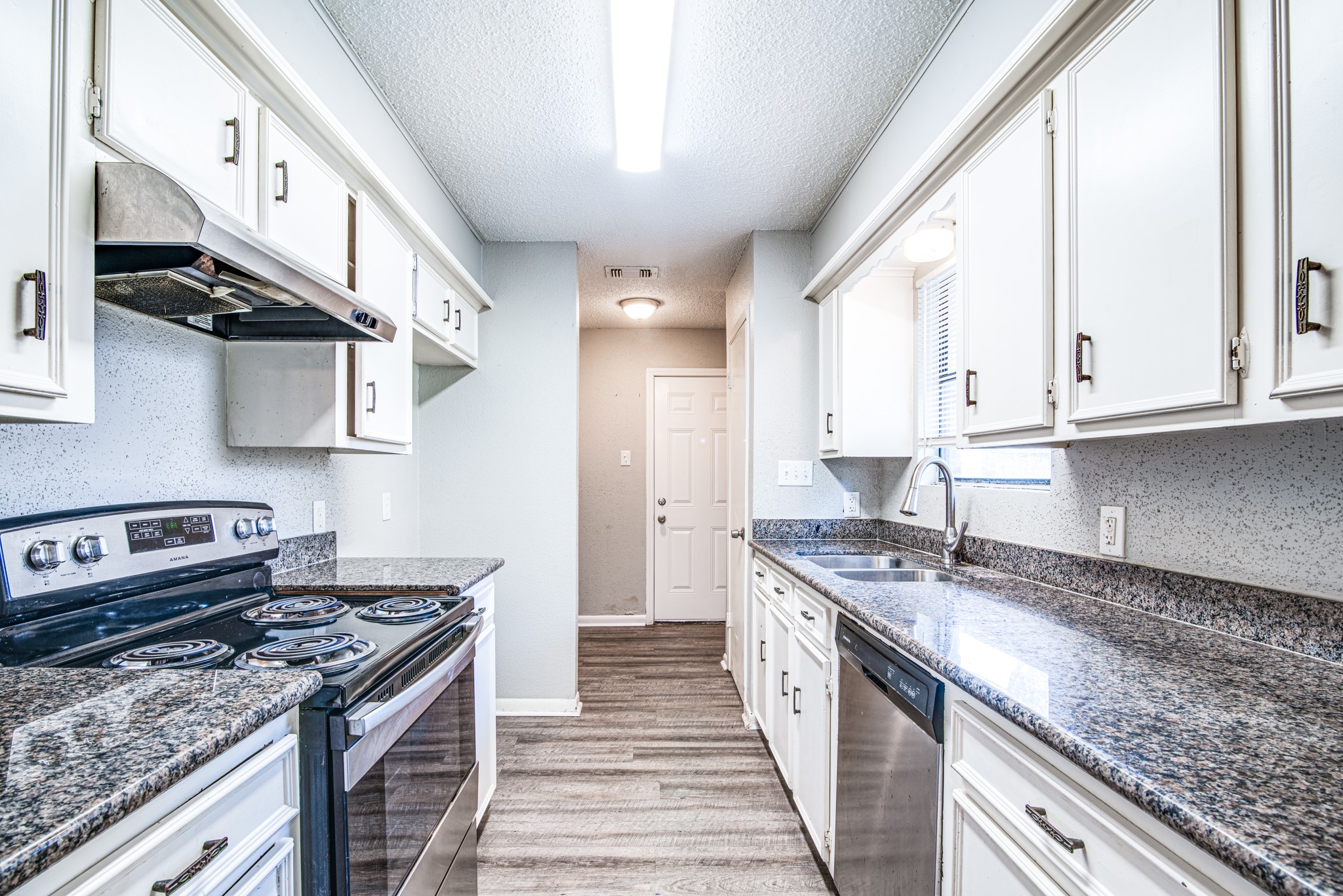 828 Noreda Street Angleton, TX 77515 - Photo 13 of 28 a kitchen with stainless steel appliances granite countertop a stove a sink and a granite counter tops