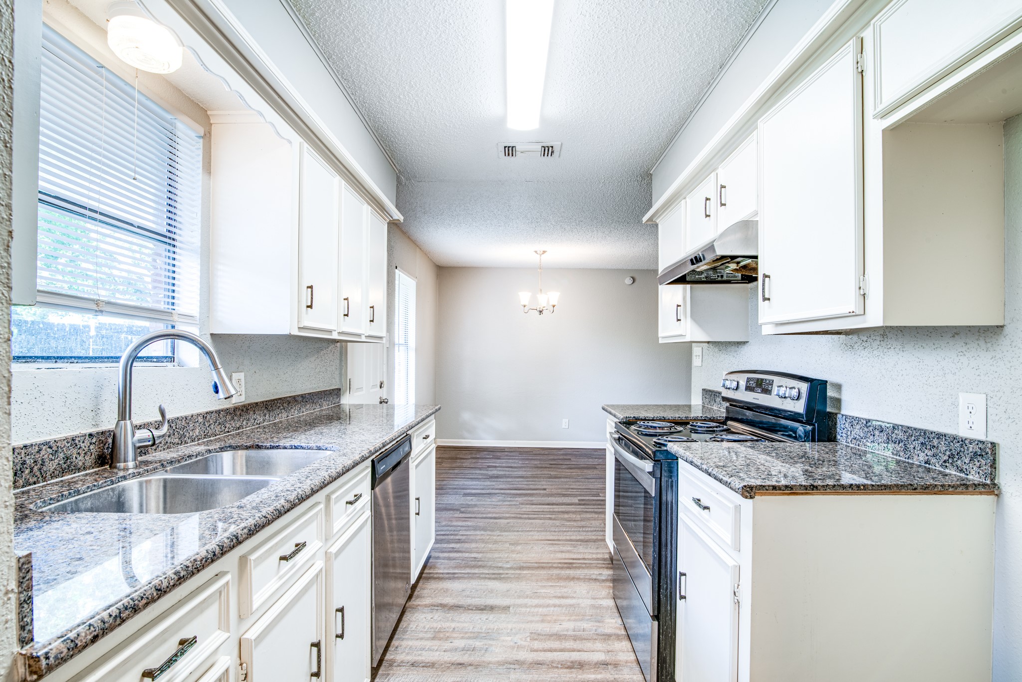 828 Noreda Street Angleton, TX 77515 - Photo 14 of 28 a kitchen with stainless steel appliances granite countertop a sink stove and cabinets
