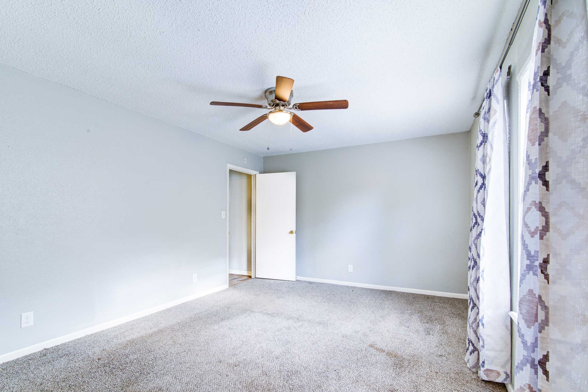 828 Noreda Street Angleton, TX 77515 - Photo 16 of 28 an empty room with ceiling fan and window
