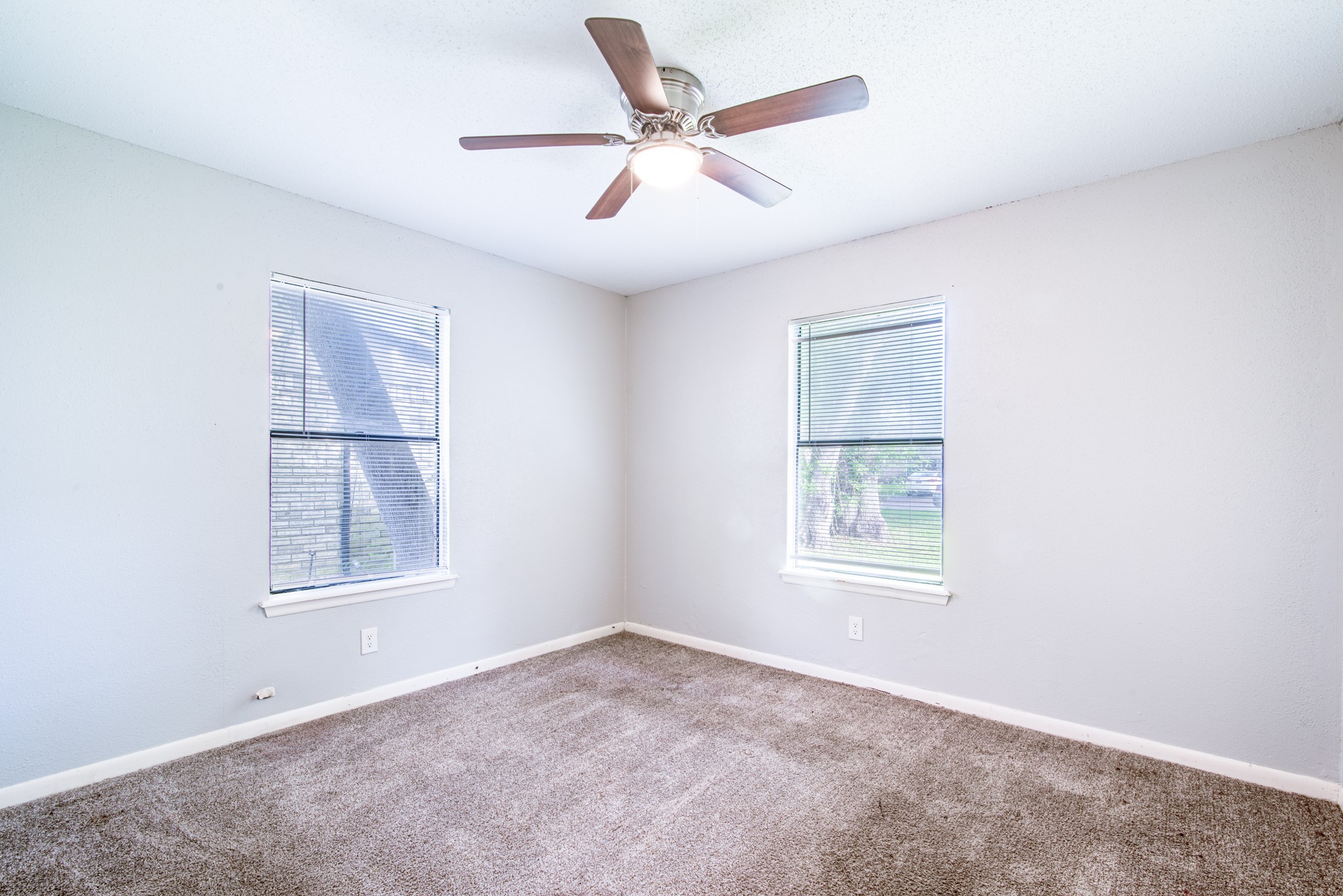 828 Noreda Street Angleton, TX 77515 - Photo 19 of 28 an empty room with windows and fan