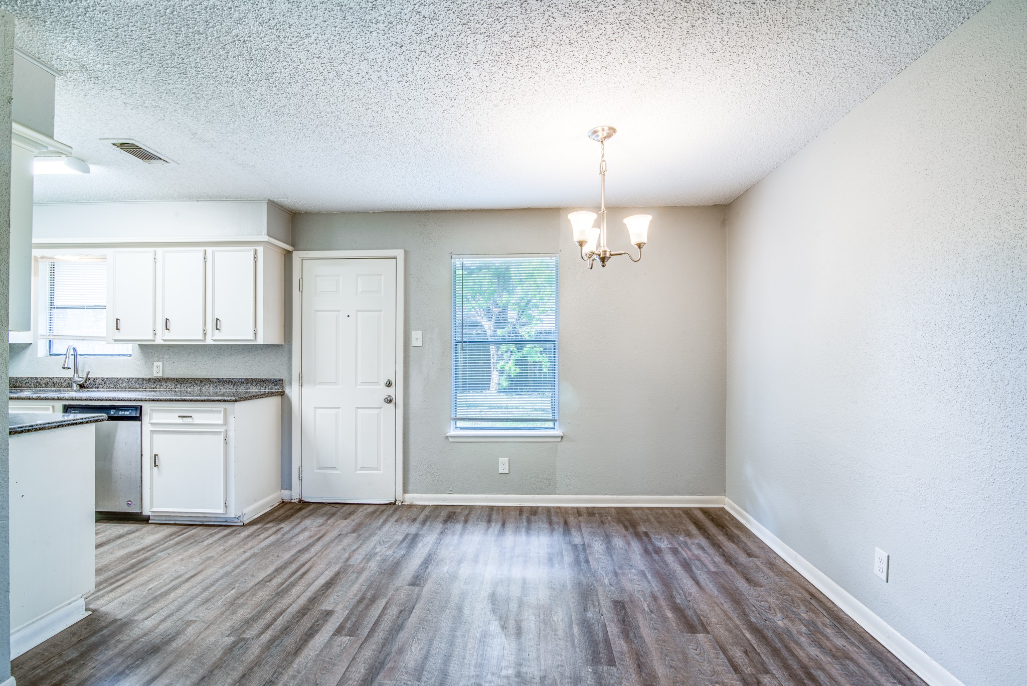 828 Noreda Street Angleton, TX 77515 - Photo 2 of 28 a view of a kitchen with granite countertop cabinets and wooden floor