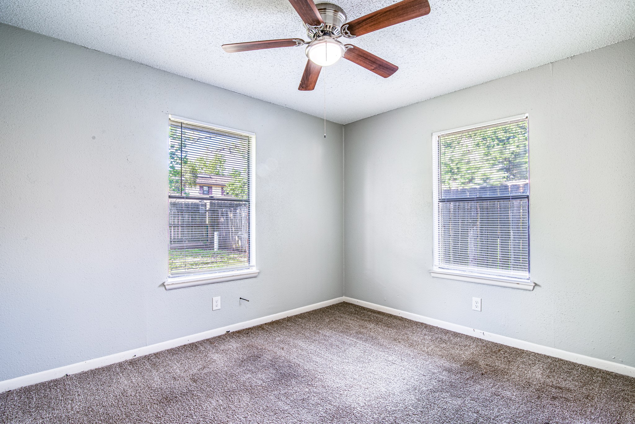828 Noreda Street Angleton, TX 77515 - Photo 21 of 28 an empty room with a window and a ceiling fan