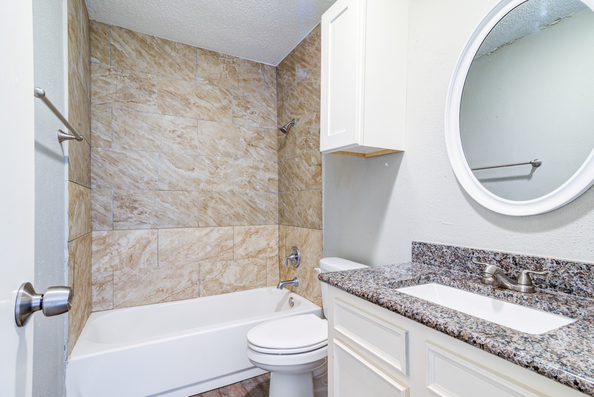 828 Noreda Street Angleton, TX 77515 - Photo 23 of 28 a bathroom with a granite countertop bathtub shower sink mirror and toilet