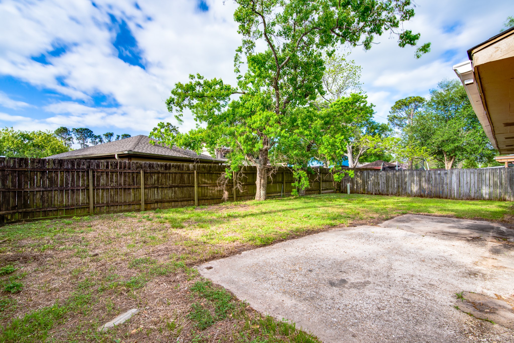 828 Noreda Street Angleton, TX 77515 - Photo 28 of 28 a backyard of a house with lots of green space