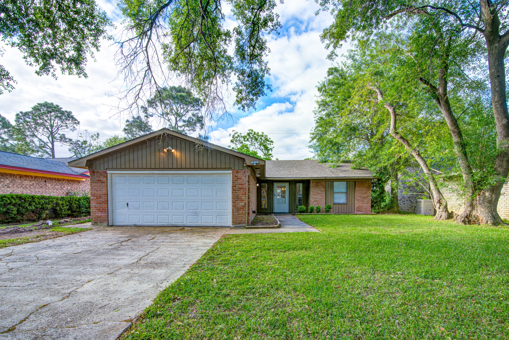 828 Noreda Street Angleton, TX 77515 - Photo 4 of 28 a front view of a house with a yard and garage