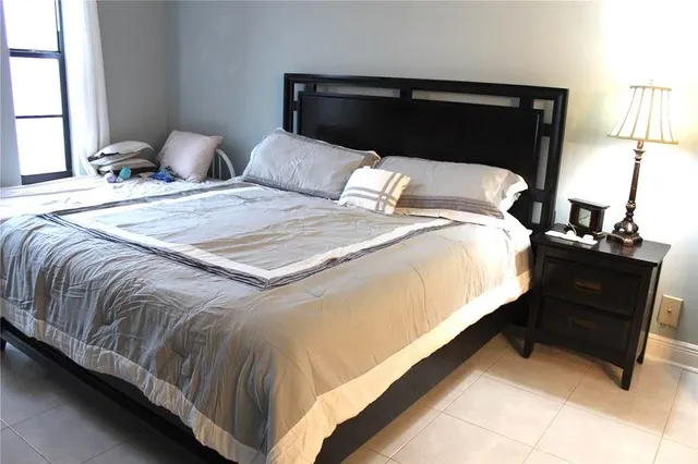 a bedroom with a bed and window