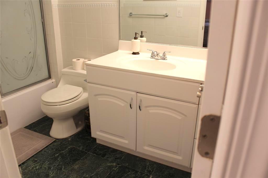 1000 South Ocean Boulevard, Unit 11K Pompano Beach, FL 33062 - Photo 19 of 25 a bathroom with a sink toilet and mirror
