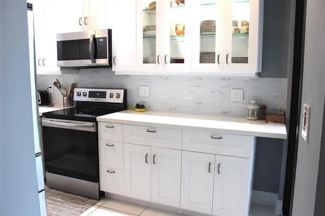 a kitchen with stainless steel appliances white cabinets and a sink
