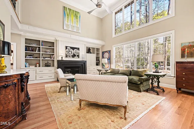 a living room with furniture a fireplace and a table