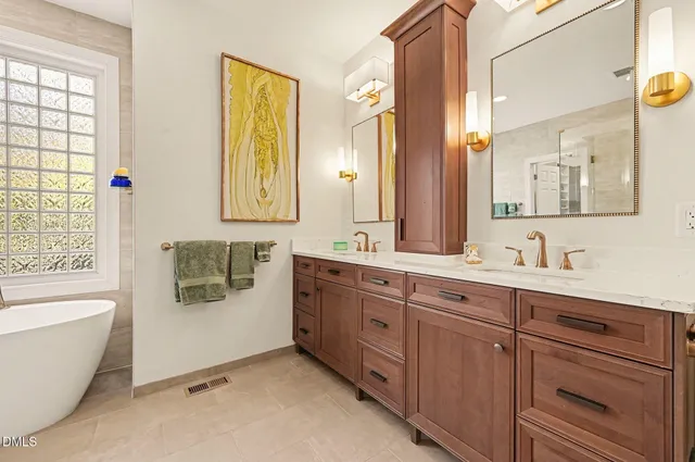 a bathroom with a double vanity sink mirror and toilet
