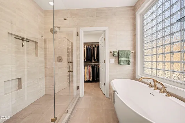 a bed sitting in a room next to a lamp