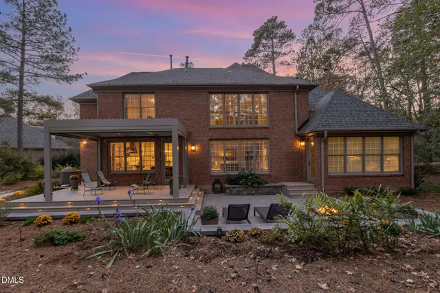 a view of a building with sitting area and floor to ceiling window