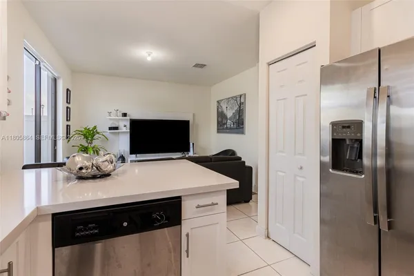 a kitchen with a sink and refrigerator