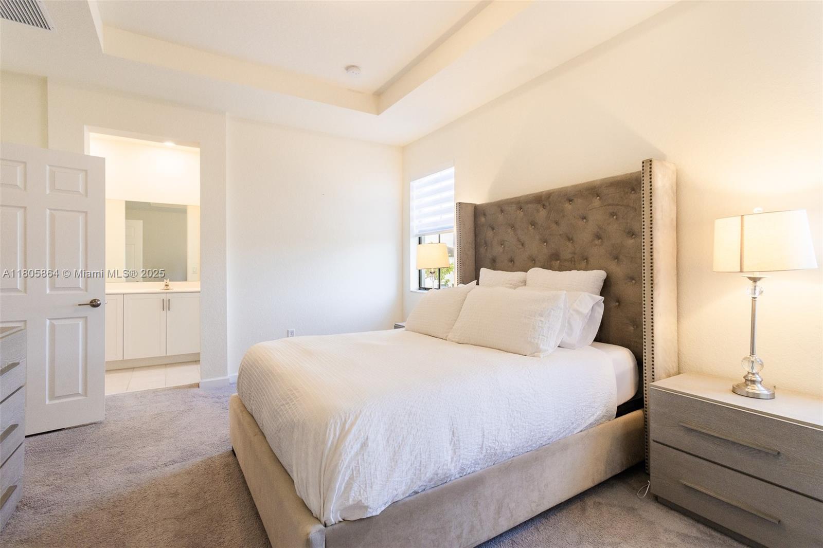 10966 West 33rd Way Hialeah, FL 33018 - Photo 18 of 43 a bedroom with a bed and a view of bathroom