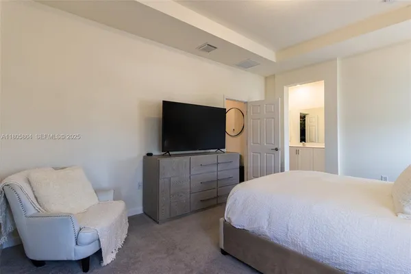 a bedroom with a bed and a flat screen tv