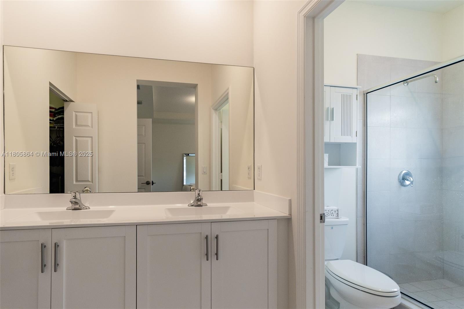 10966 West 33rd Way Hialeah, FL 33018 - Photo 22 of 43 a bathroom with a double vanity sink toilet and shower