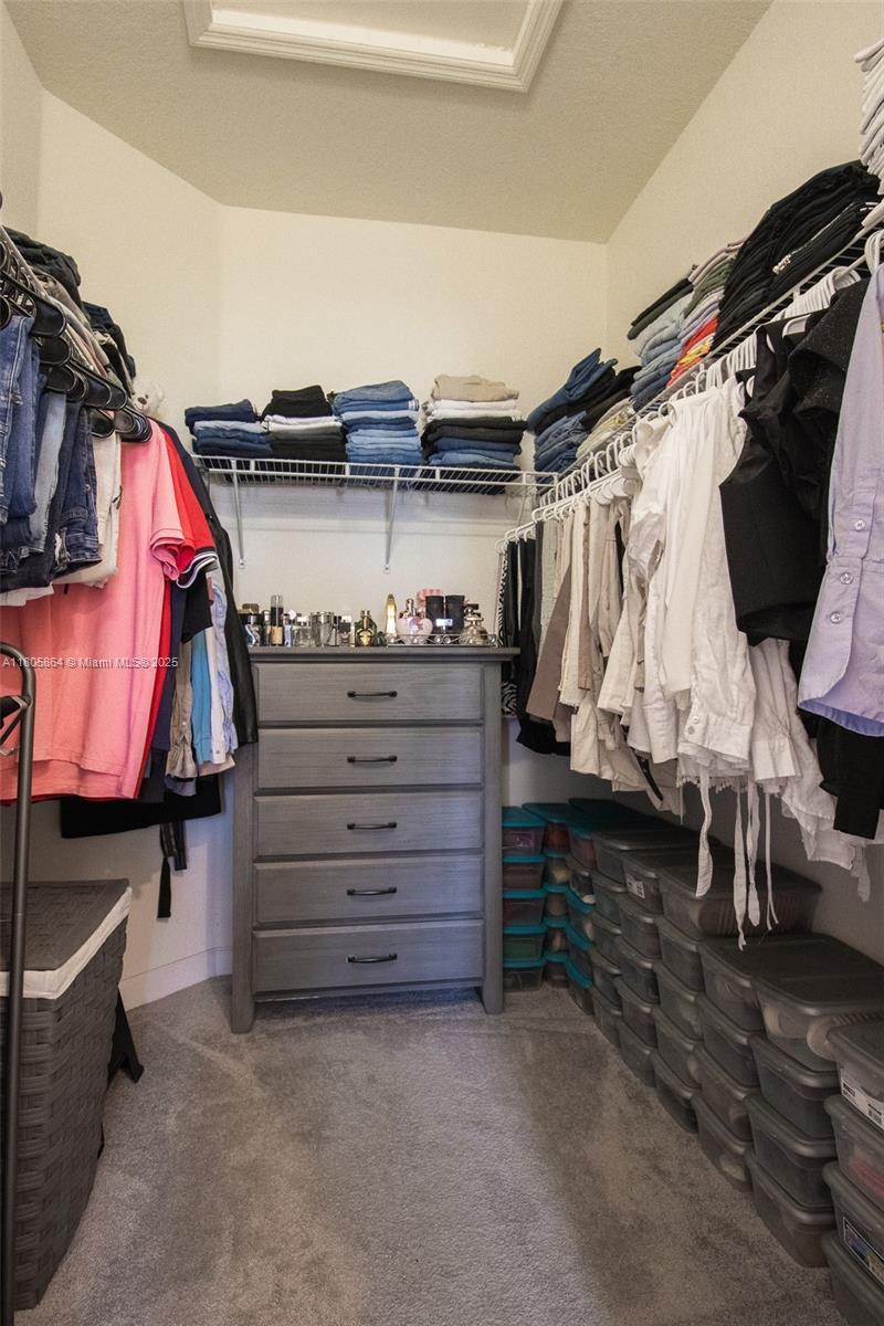 10966 West 33rd Way Hialeah, FL 33018 - Photo 23 of 43 a view of walk in closet with clothes and shoes