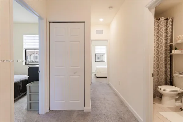 a bathroom with a granite countertop sink a toilet and shower
