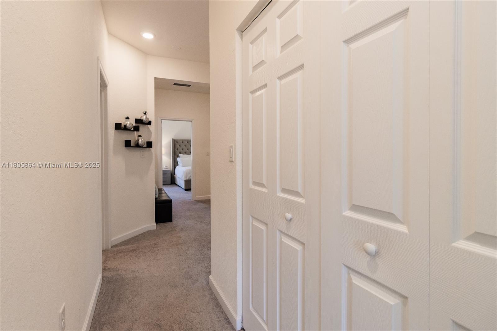 10966 West 33rd Way Hialeah, FL 33018 - Photo 29 of 43 a view of a hallway with white walls and stairs