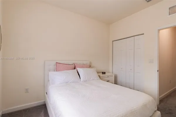 a bedroom with a bed and a night stand