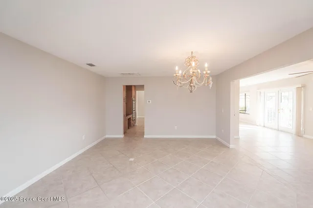 a view of a hallway with wooden floor and a kitchen