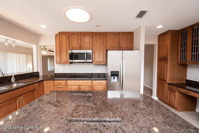 a large white kitchen with a large window