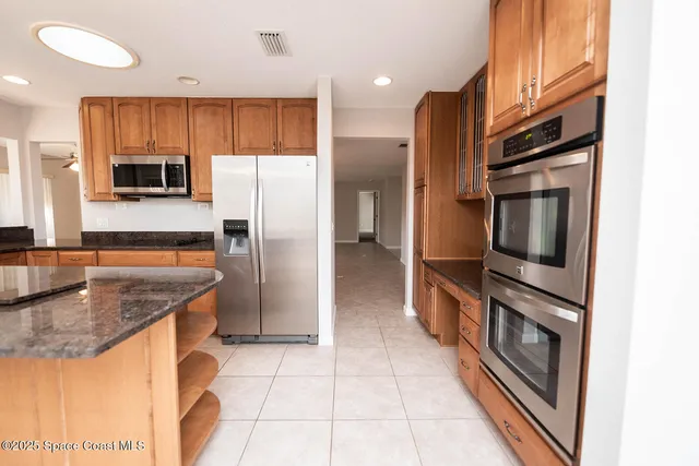 a kitchen with sink and refrigerator