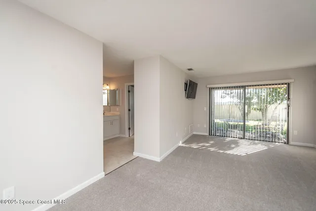 a en suite bathroom with a granite countertop sink and a mirror