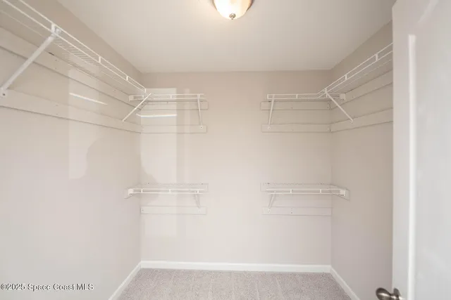 a spacious bathroom with a double vanity sink and a mirror