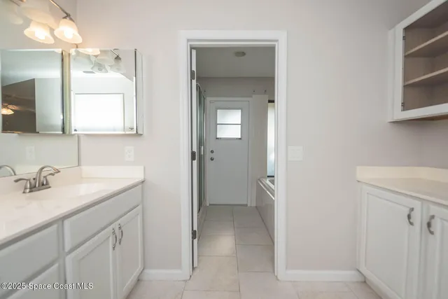 a bathroom with a double vanity sink a mirror and a shower