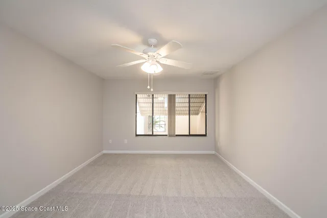 a patio with a table and chairs under an umbrella