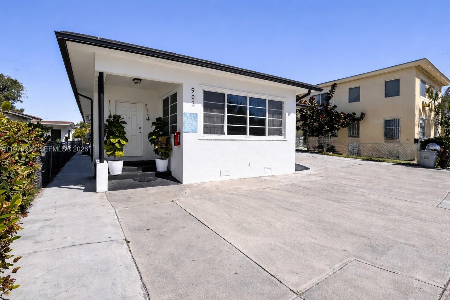 903 80th Street Miami Beach, FL 33141 - Photo 2 of 15 a front view of a house with a yard