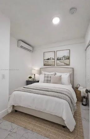 a bedroom with a bed and painting on the wall