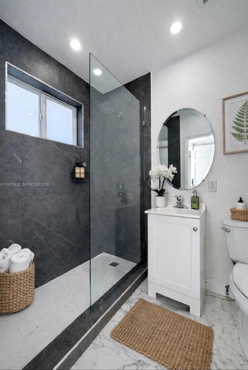 903 80th Street Miami Beach, FL 33141 - Photo 5 of 15 a bathroom with a sink a toilet and shower