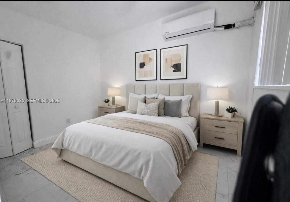 903 80th Street Miami Beach, FL 33141 - Photo 6 of 15 a bedroom with a bed and a window