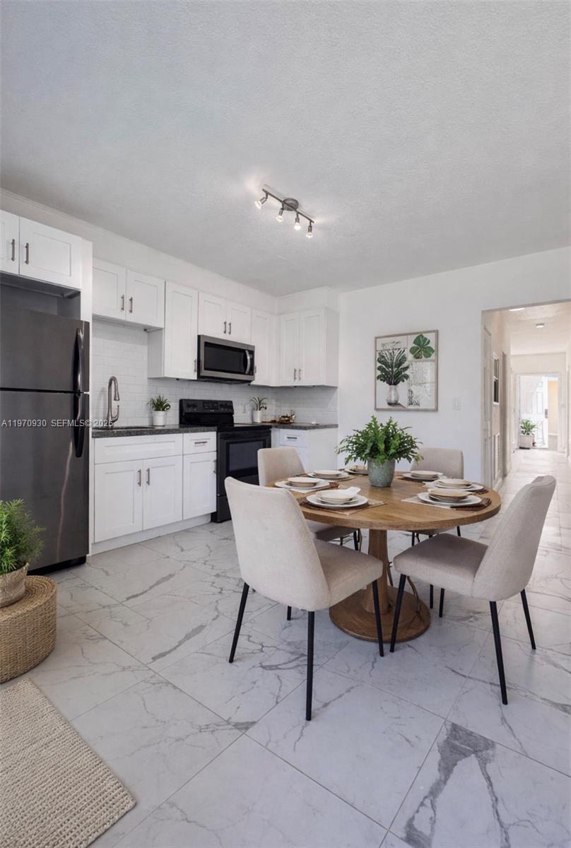 903 80th Street Miami Beach, FL 33141 - Photo 7 of 15 a view of a dining room with furniture