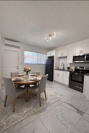 a kitchen with a table and chairs in it