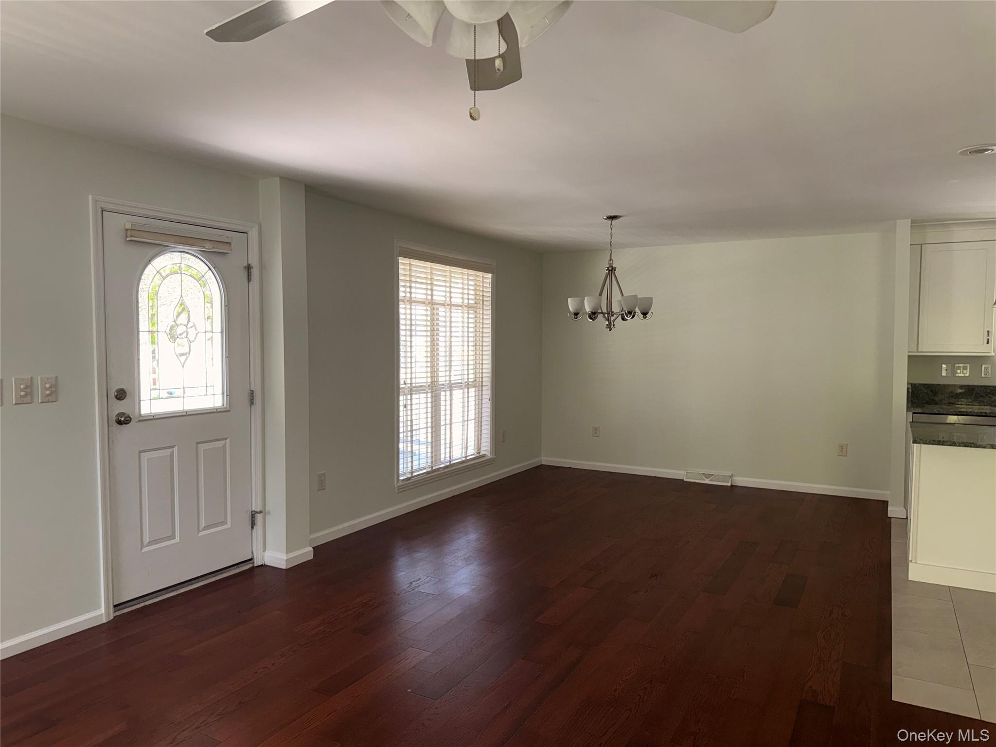 1661 Old Country Road, Unit 516 Riverhead, NY 11901 - Photo 11 of 50 wooden floor in an empty room with a window