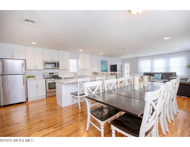 a kitchen with stainless steel appliances granite countertop a stove refrigerator and cabinets