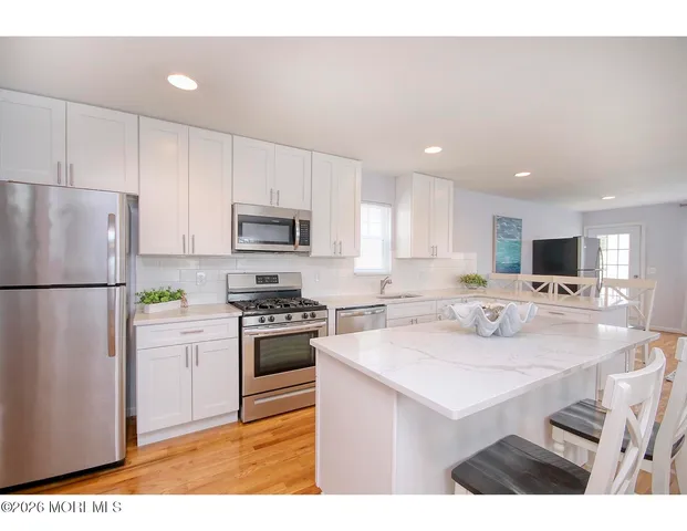 a kitchen with refrigerator cabinets and furniture