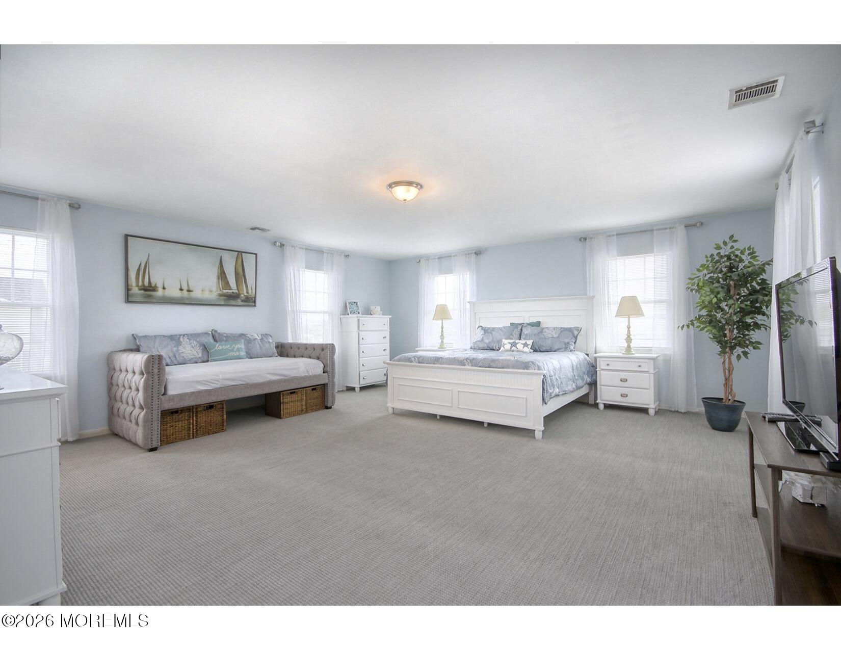 201 Arnold Avenue Point Pleasant Beach, NJ 08742 - Photo 19 of 33 a spacious bedroom with a bed and a couch