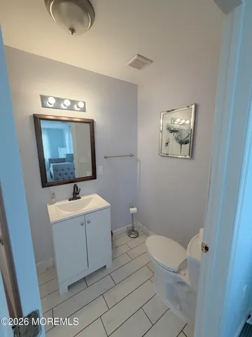 a bathroom with a sink mirror vanity and toilet