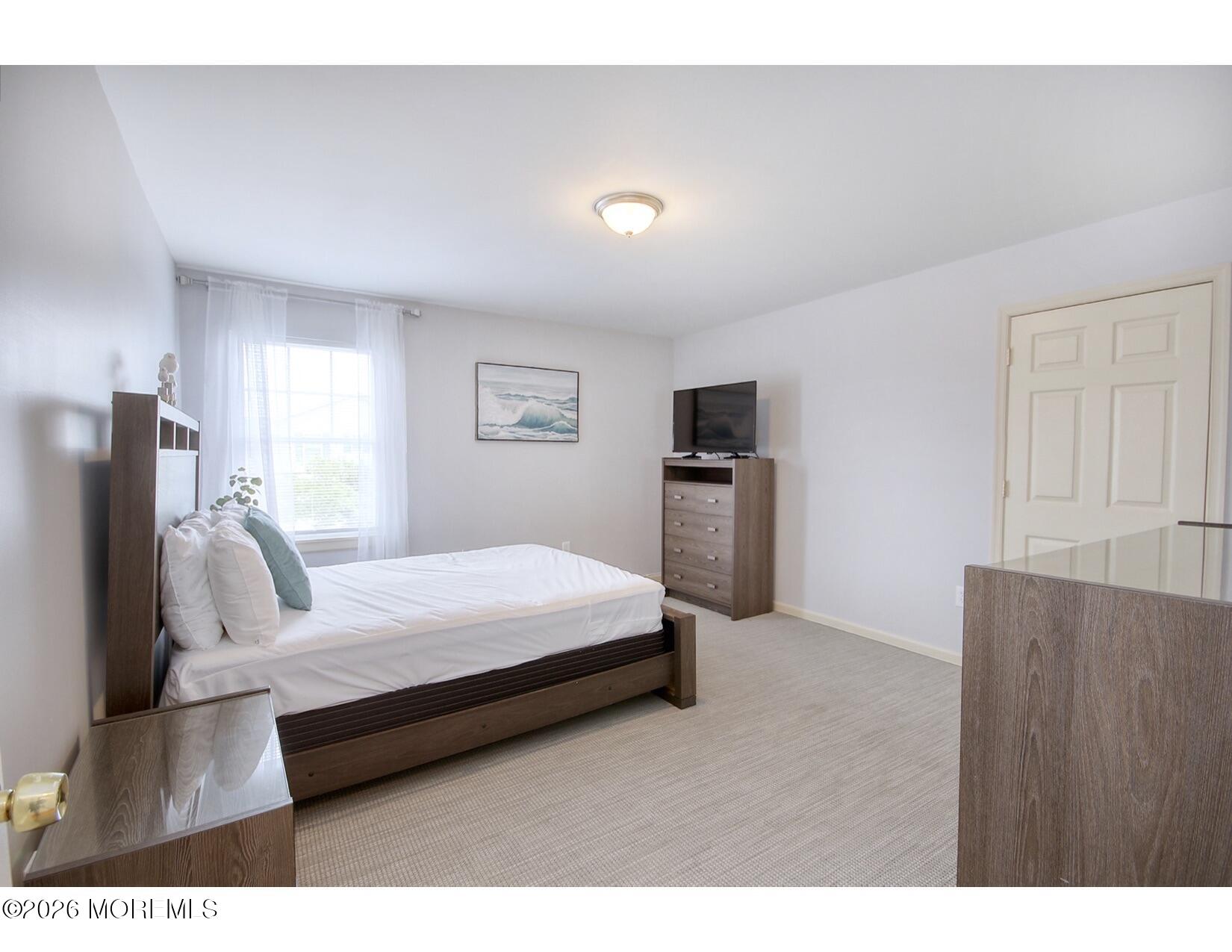 201 Arnold Avenue Point Pleasant Beach, NJ 08742 - Photo 25 of 33 a room with a bed and a television