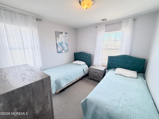 a bedroom with two beds and a window