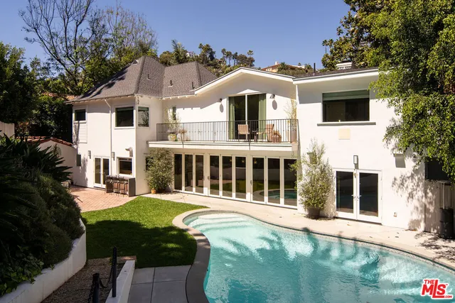 a front view of a house with a yard table and chairs