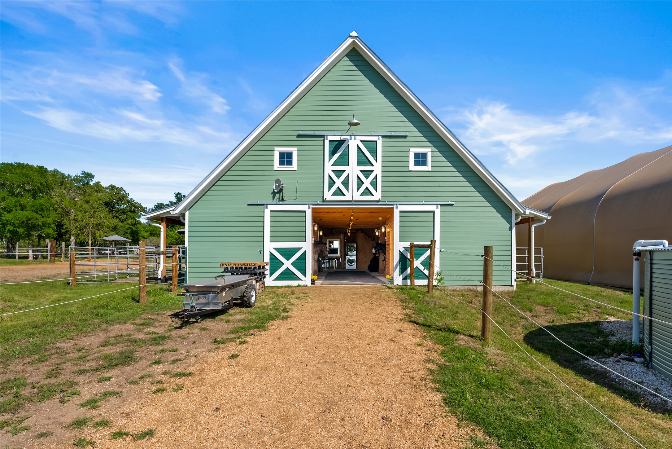 7670 Nez Perce Trace Manor, TX 78653 - Photo 32 of 40 Rear view of house featuring a barn, fence, and an outdoor structure